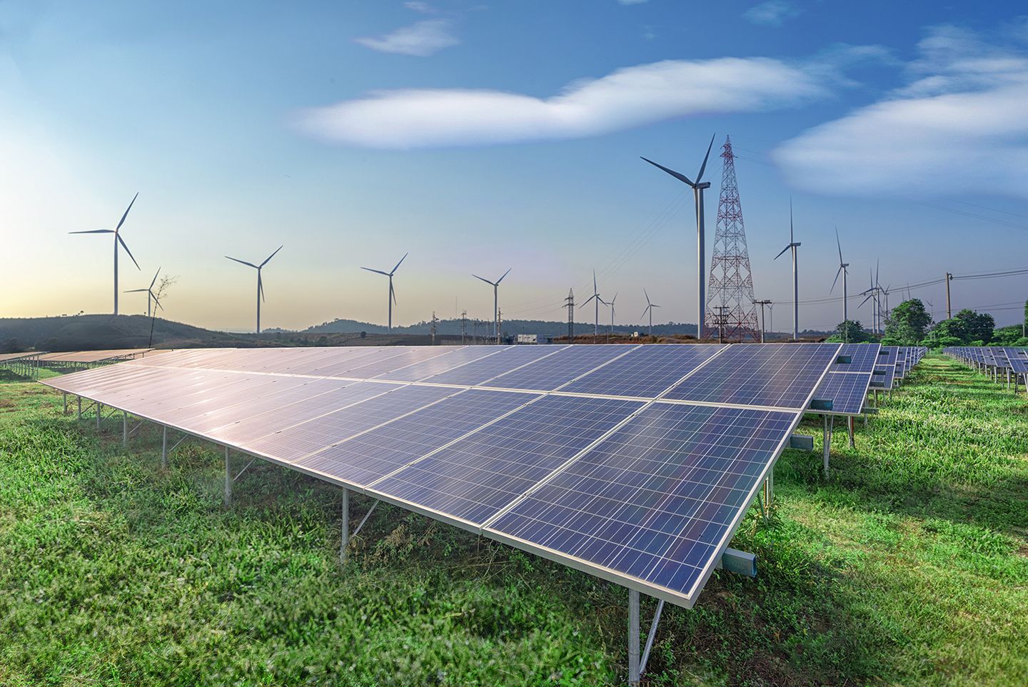 renewable-energy-solar-panels-wind-turbines-green-grass-blue-sky